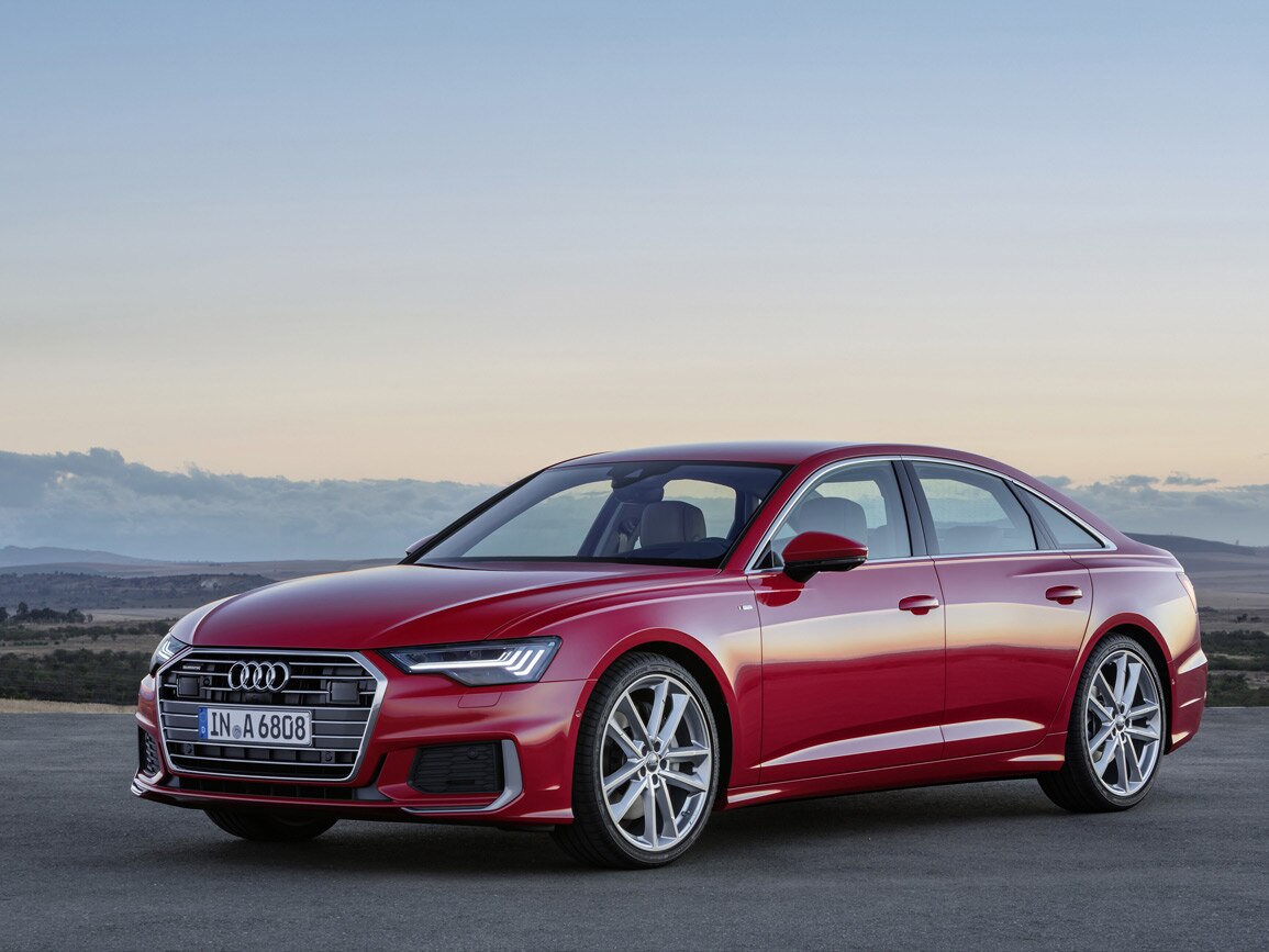 A red Audi A6 Saloon against a sunset backdrop