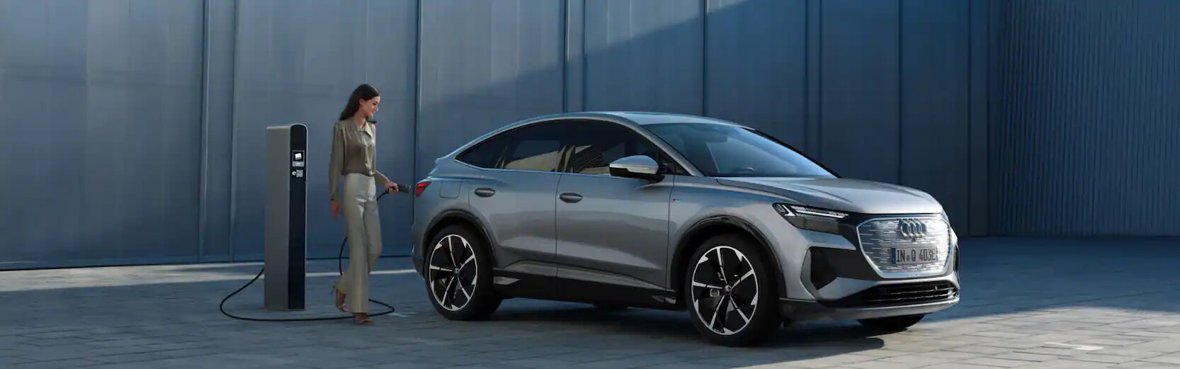 Woman charging her Audi e-tron Sportback.