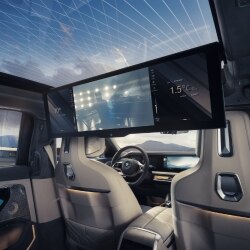 Image of the interior of a BMW i7, showing the large screen in the back seats