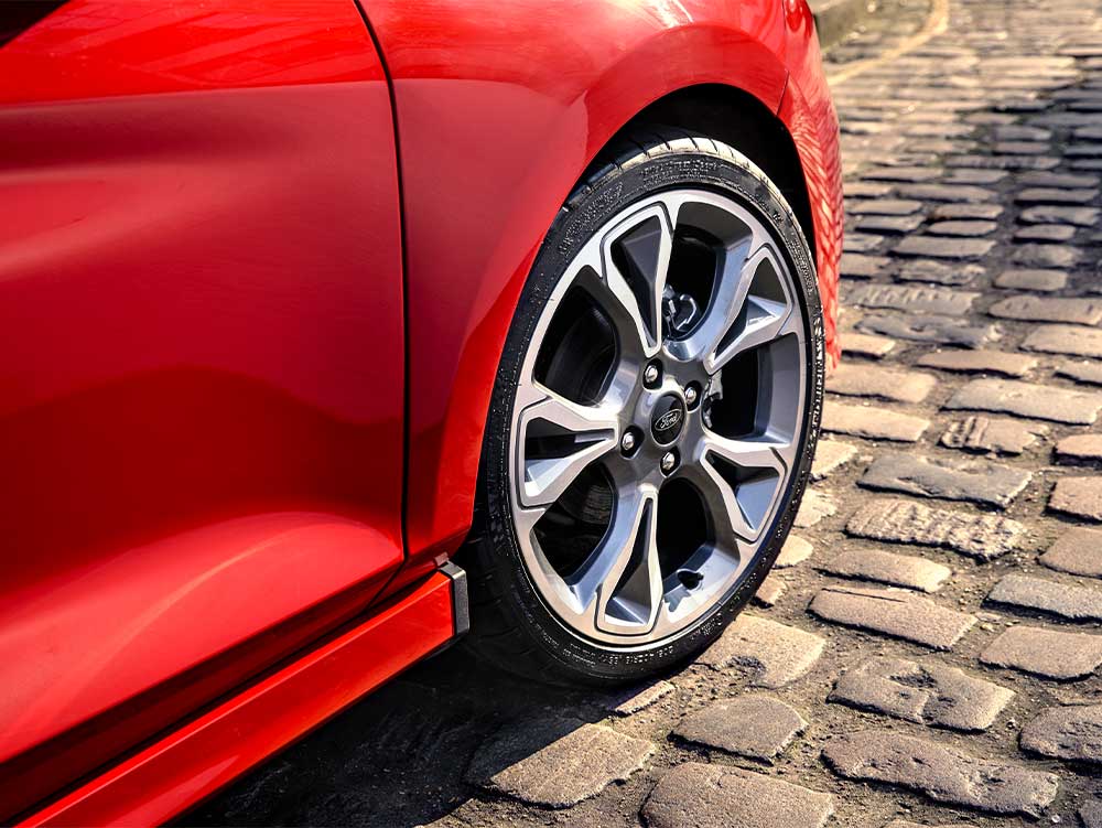 Used Ford Fiesta van Image Card featuring a red second hand ford fiesta van front right wheel and alloy.