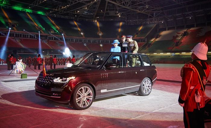 Favourite cars of the royal family blog image featuring Queen Elizabeth standing in a Land Rover Range Rover in Celtic Park Glasgow