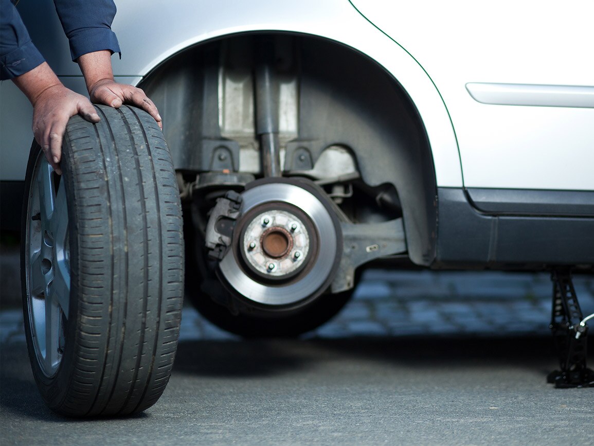 A technician examining a tyre