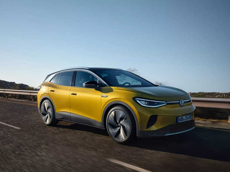 Battery Electric Vehicle BEV Image Card - Featuring a gold Volkswagen id4 full electric car driving on a country road.