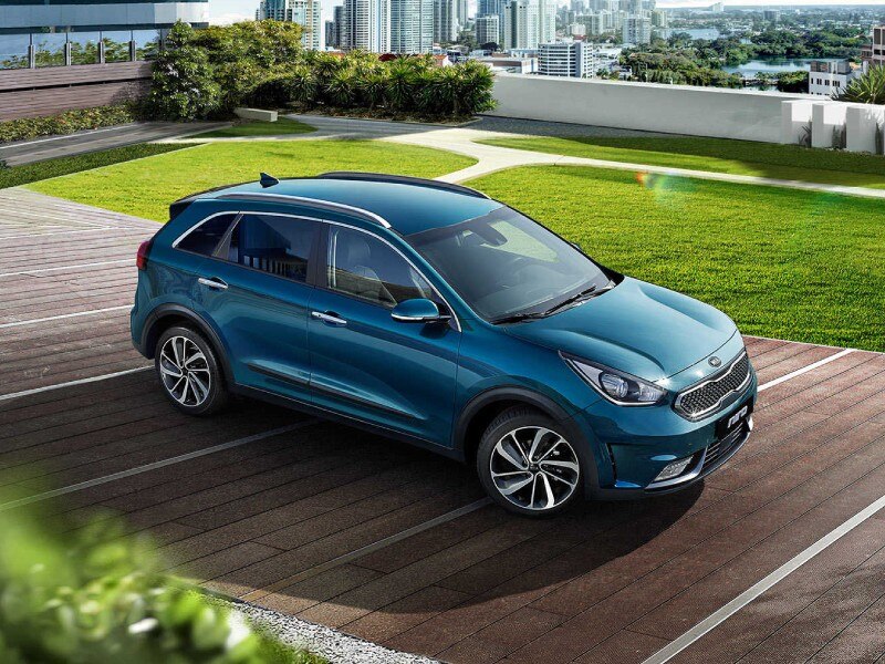 Mild Hybrid Electric Vehicles MHEVs Image Card - Featuring a side profile shot of a Blue Kia Niro Mild Hybrid vehicle Parked in a space in an empty car park. 