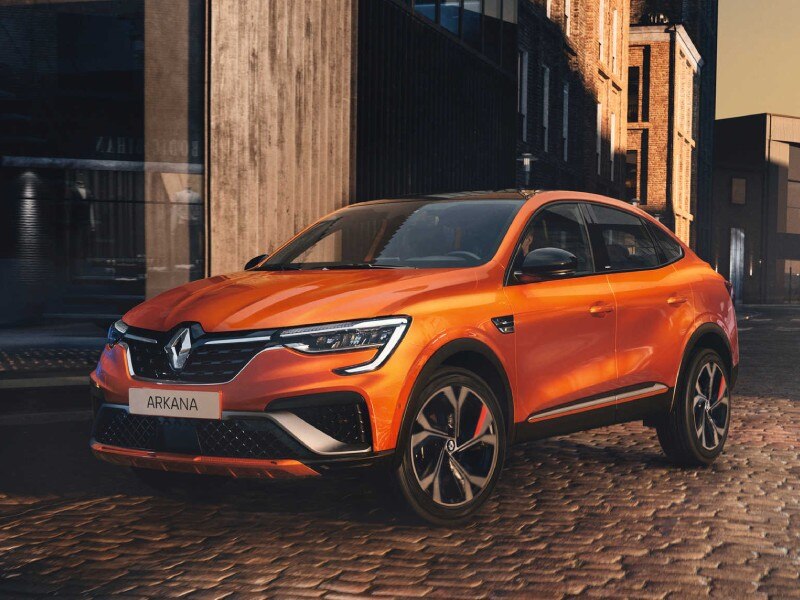 Mild Hybrid Electric Vehicles MHEVs Image Card - Featuring a side profile shot of an orange Renault Arkana Mild Hybrid vehicle Parked in an old town centre on cobblestones.