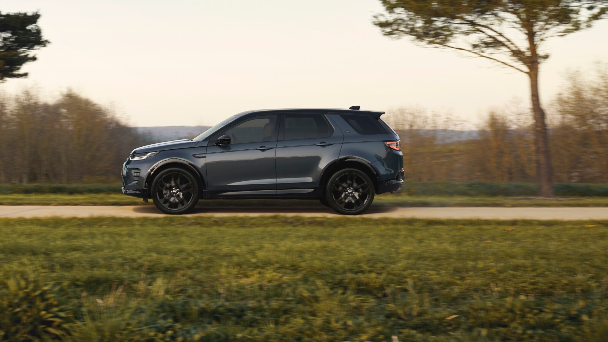 Grey Discovery Sport  24 Model Year driving along country road