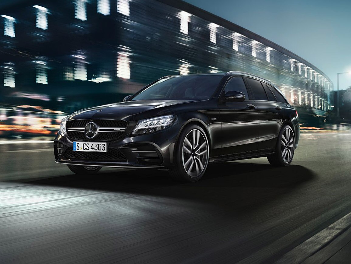 A black Mercedes-AMG C 43 Estate travelling through the city
