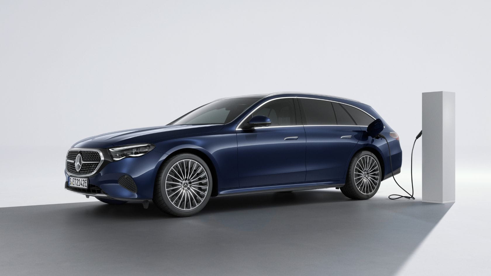 E-Class Estate parked front 3 quarters with yellow and purple background