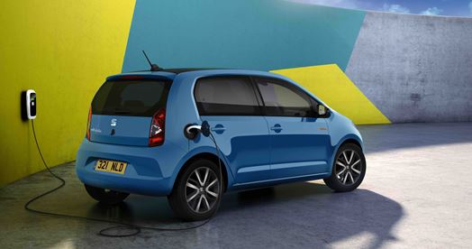Cheapest Electric Cars on the market Lookers Blog Image featuring the all electric SEAT Mii Electric, one of the most affordable electric cars rear shot of the vehicle in blue parked and plugged in to a public electric car charger.
