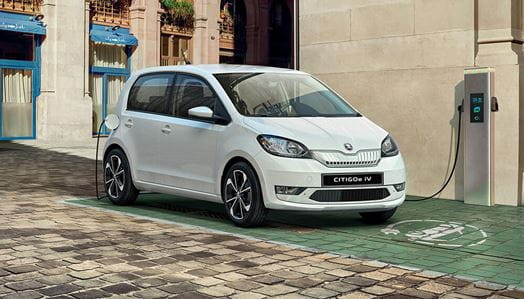 Cheapest Electric Cars on the market Lookers Blog image featuring the electric Skoda Citigo e affordable electric vehicle in white using a public electric car charger