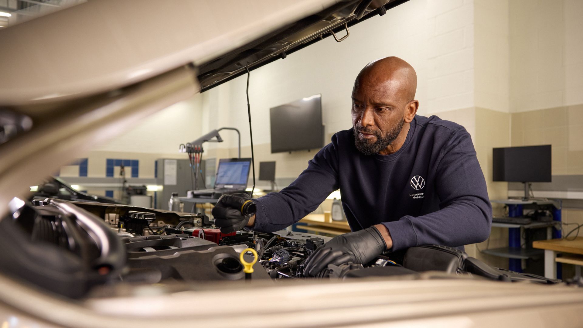 A Volkswagen Commercial Vehicles technician working on a vehicle